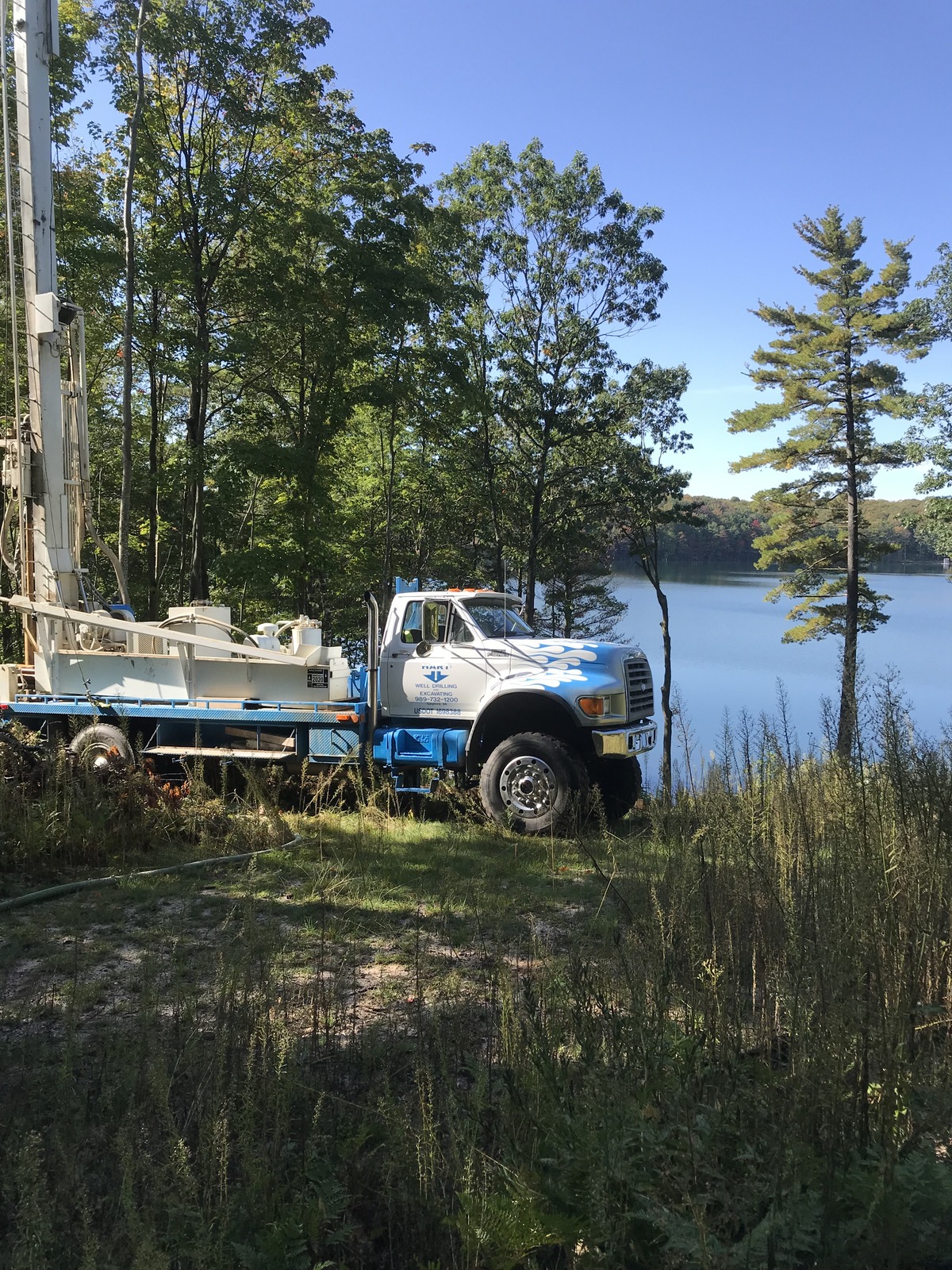 The Hart Well Drilling & Repair Work Truck in Front of a Scenic Lake
