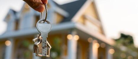 Smiling Central Florida homebuyers holding house keys after closing, symbolizing successful home sale in Winter Springs, FL