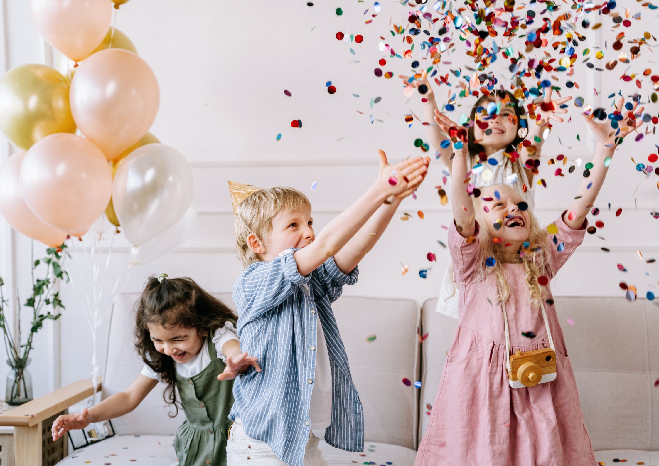Excited children celebrating with confetti and party decorations Excited children celebrating with confetti and party decorations