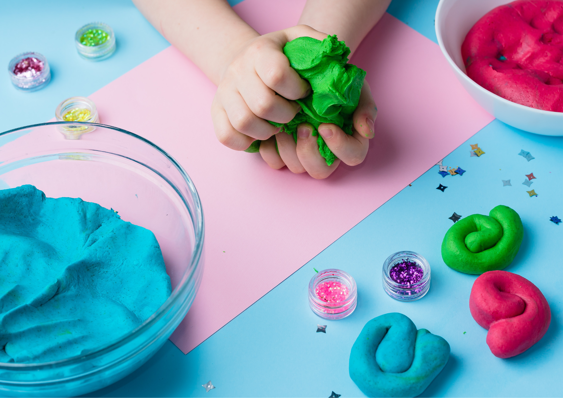 Children playing a cooperative play-dough game Children playing a cooperative play-dough game