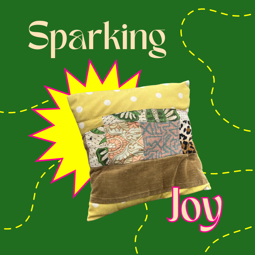 'Spark joy', patchwork pillow with stictch lines around it. 'Spark joy', patchwork pillow with stictch lines around it.