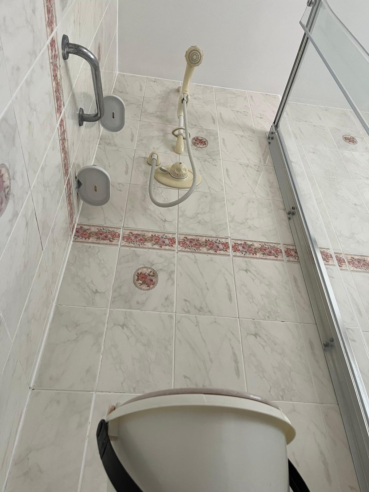 Shower with bucket below Shower with bucket below