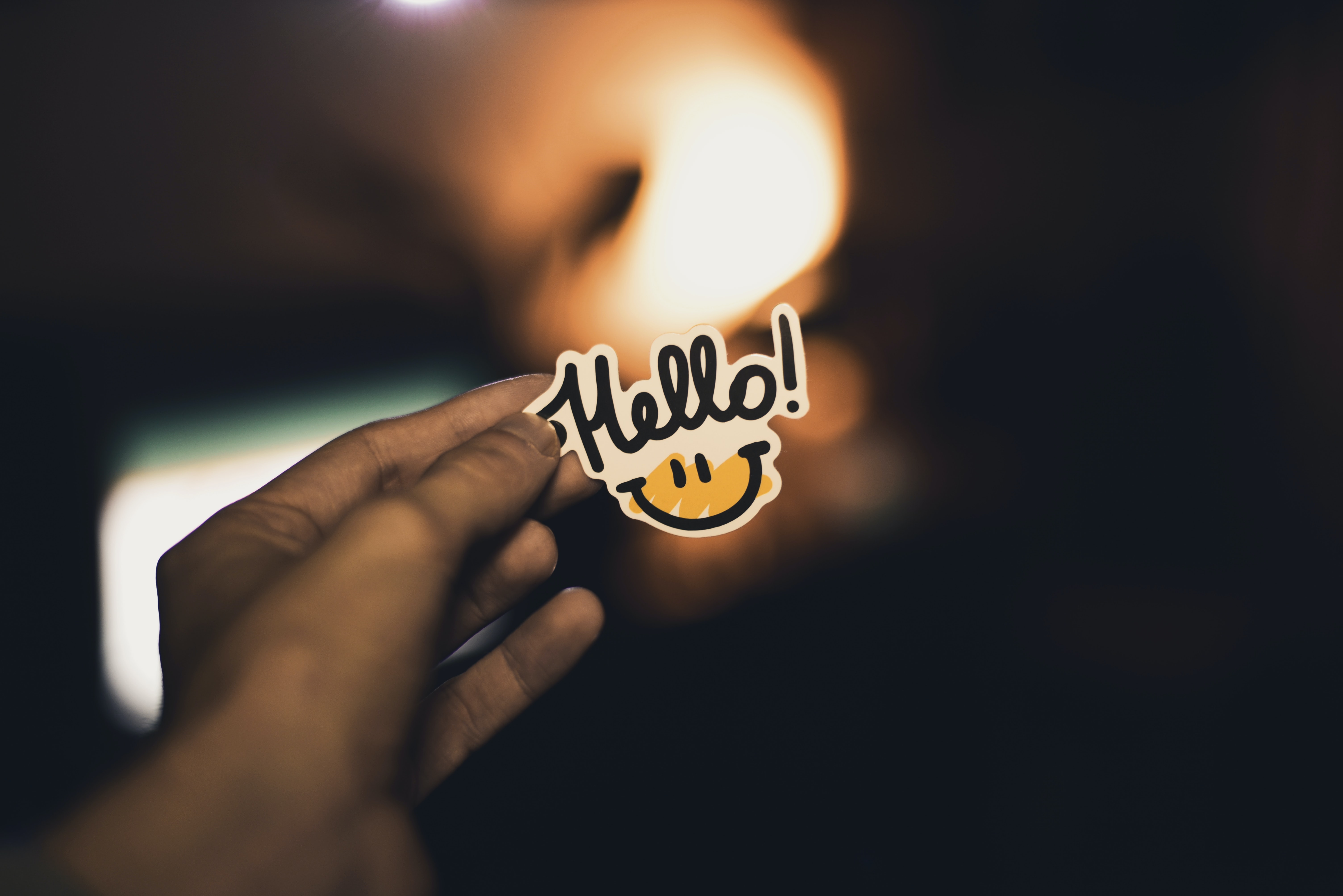 Hand holding a hello sticker Hand holding a hello sticker