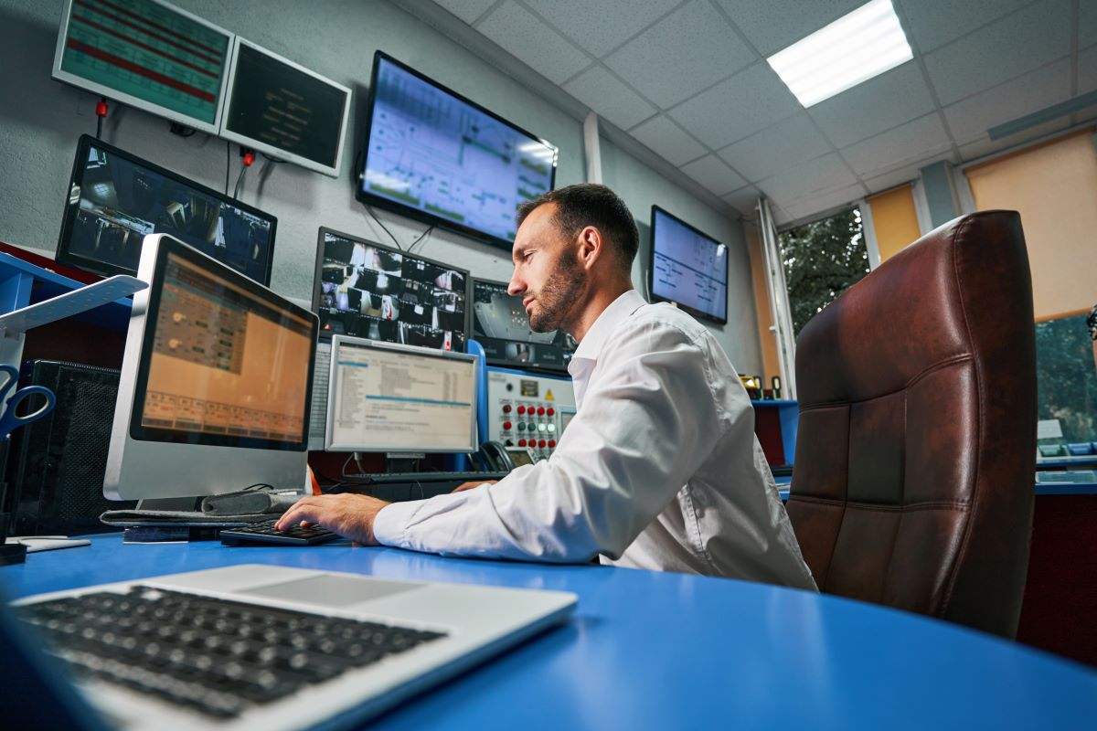 man overseeing tasks in security control room