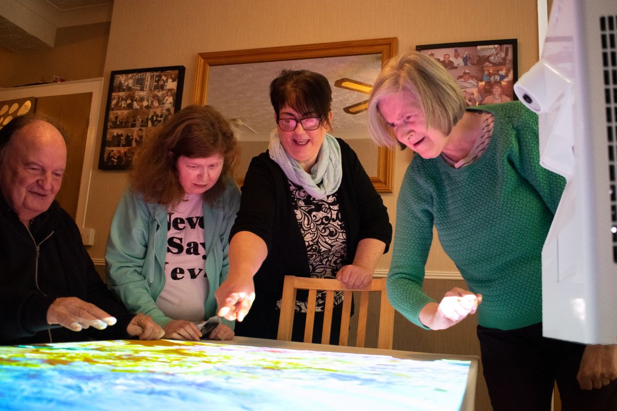 excited elderly residents exploring projection technology excited elderly residents exploring projection technology