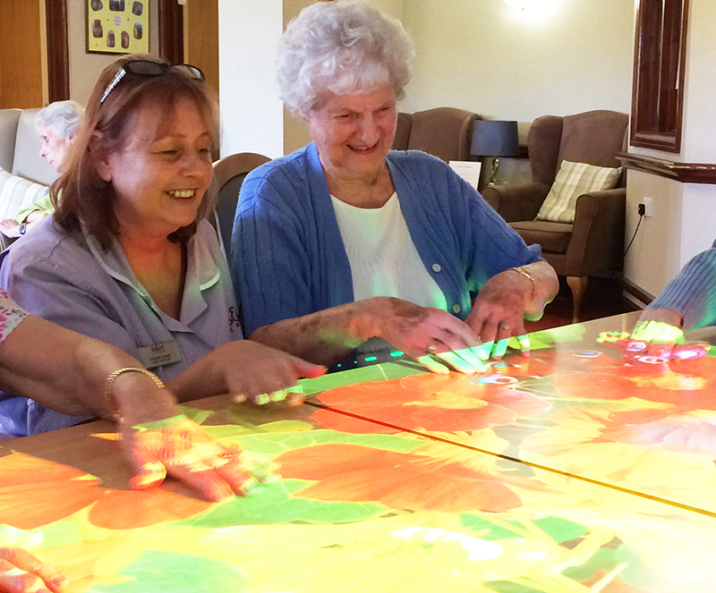 elder care patient and staff using interactive projection tech elder care patient and staff using interactive projection tech