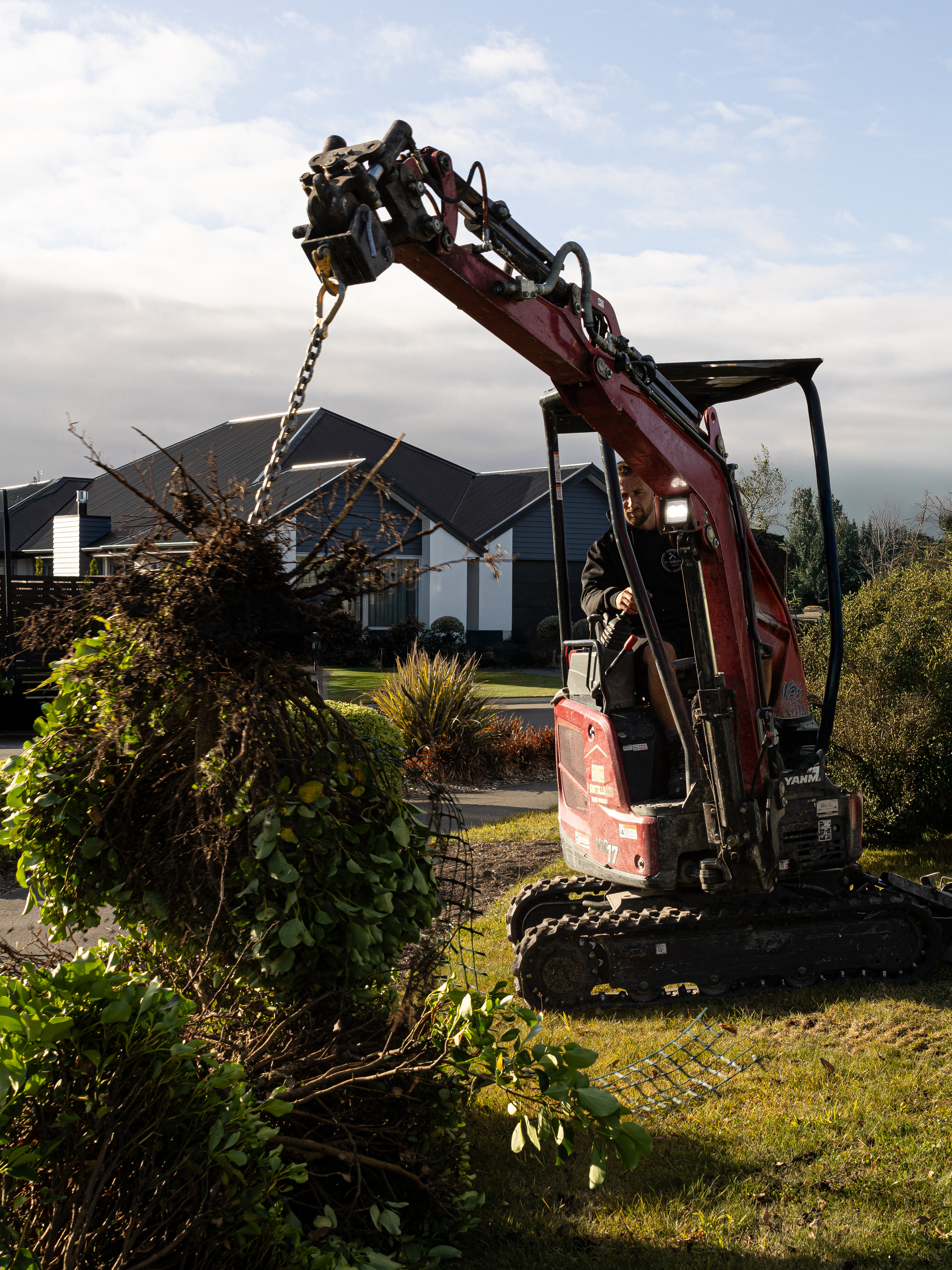 Digger clearing greenwaste