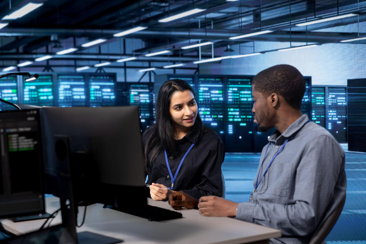 Member of managed services provider advising employee of business about IT best practices Member of managed services provider advising employee of business about IT best practices