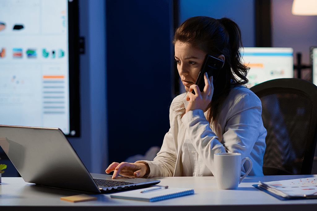 An IT support specialist answers a call in the middle of the night An IT support specialist answers a call in the middle of the night