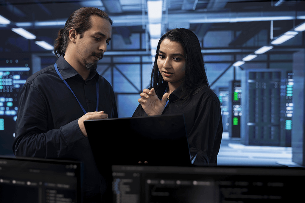 Two IT technicians work to solve a problem Two IT technicians work to solve a problem