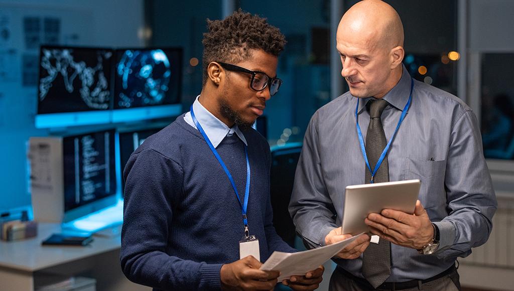 An IT specialist from an IT outsourcing provider shows proof of cybersecurity certifications. An IT specialist from an IT outsourcing provider shows proof of cybersecurity certifications.