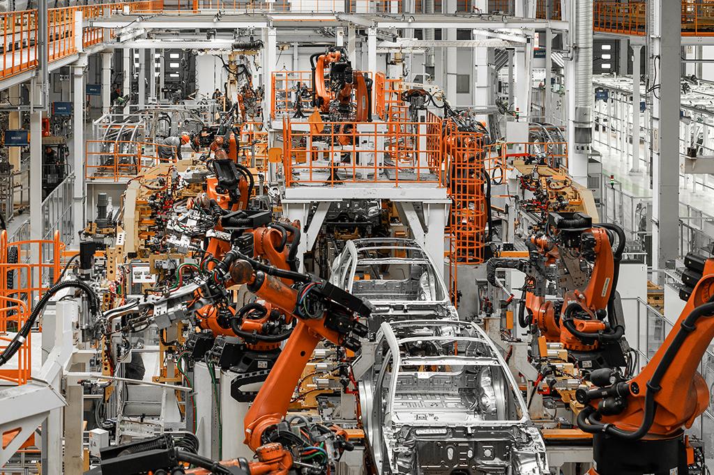 Cars on an assembly line in a vehicle manufacturing plant. Cars on an assembly line in a vehicle manufacturing plant.
