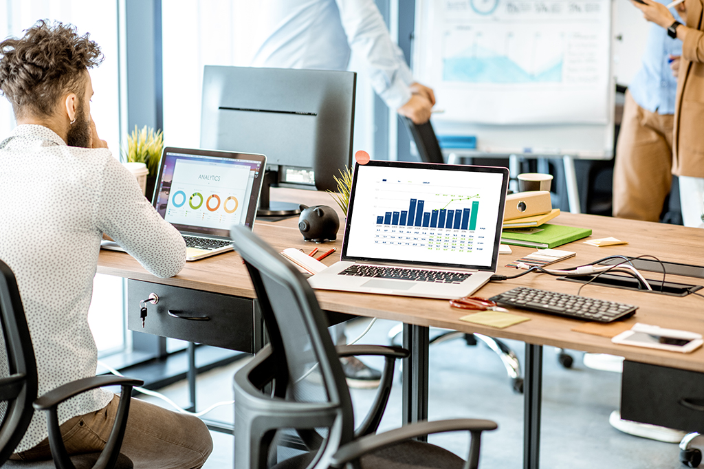 Computers showing analytics and financial reports in an office Computers showing analytics and financial reports in an office