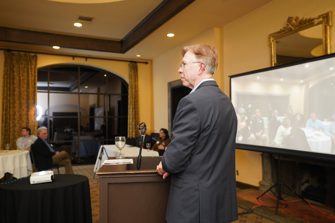 Pictured: Dr. Roger Moczygemba moderating the evening