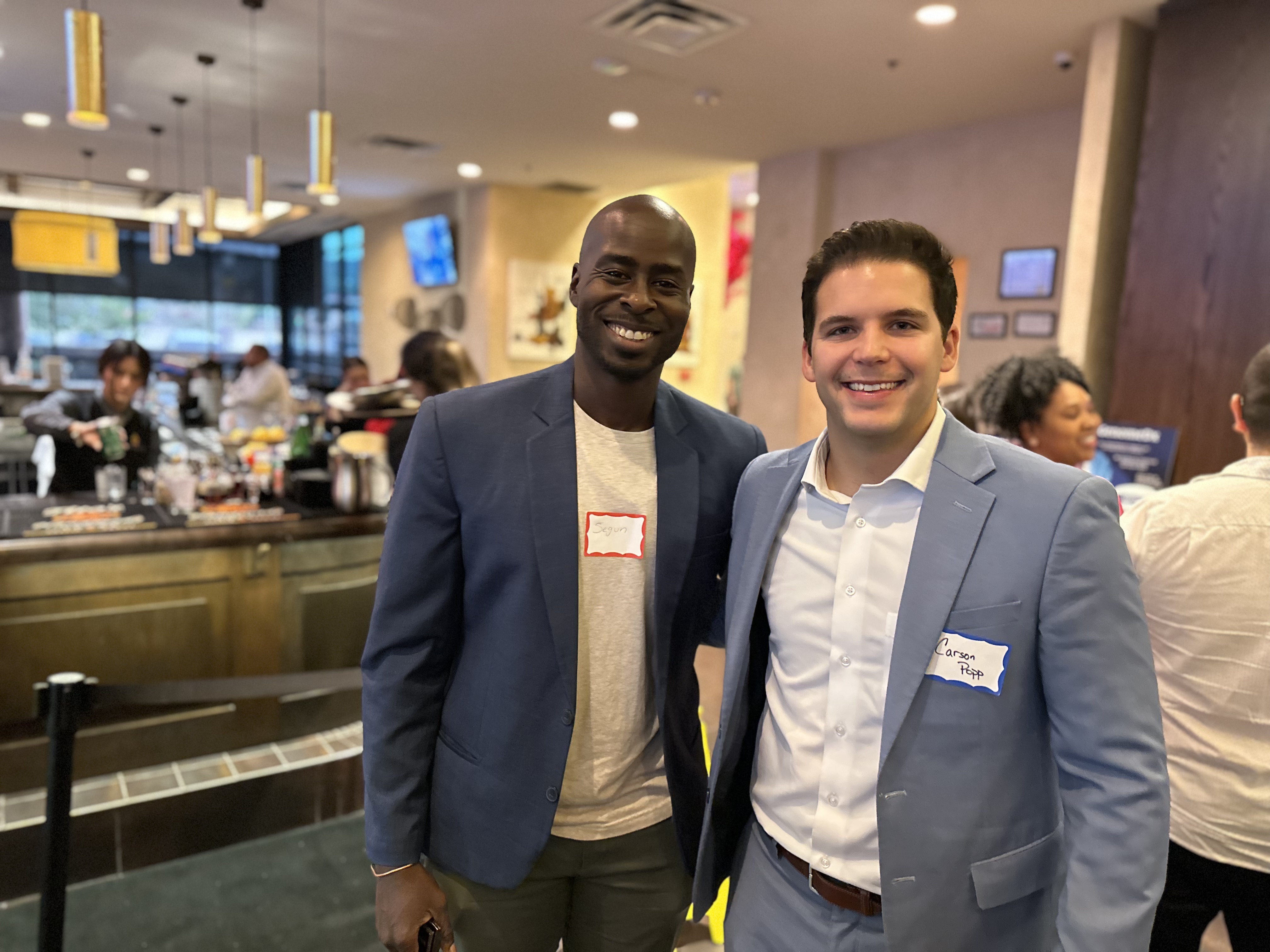 Two male SA FMMA attendees are all smiles as they pose together