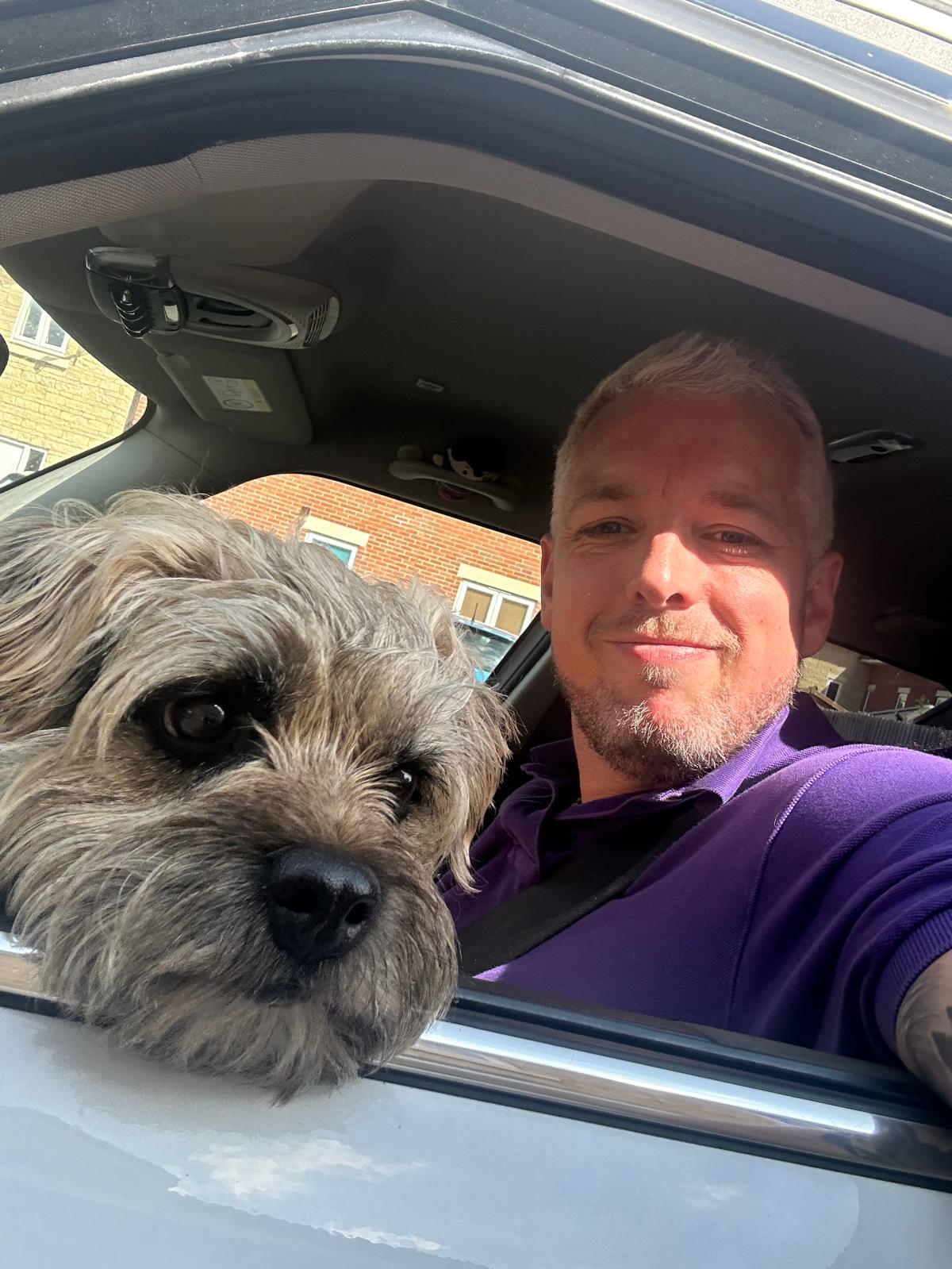 Fraser the ADHD Coach sitting in the car window with the dog to support the blog post Understanding ADHD Tax, Financial Costs & Tips to Avoid