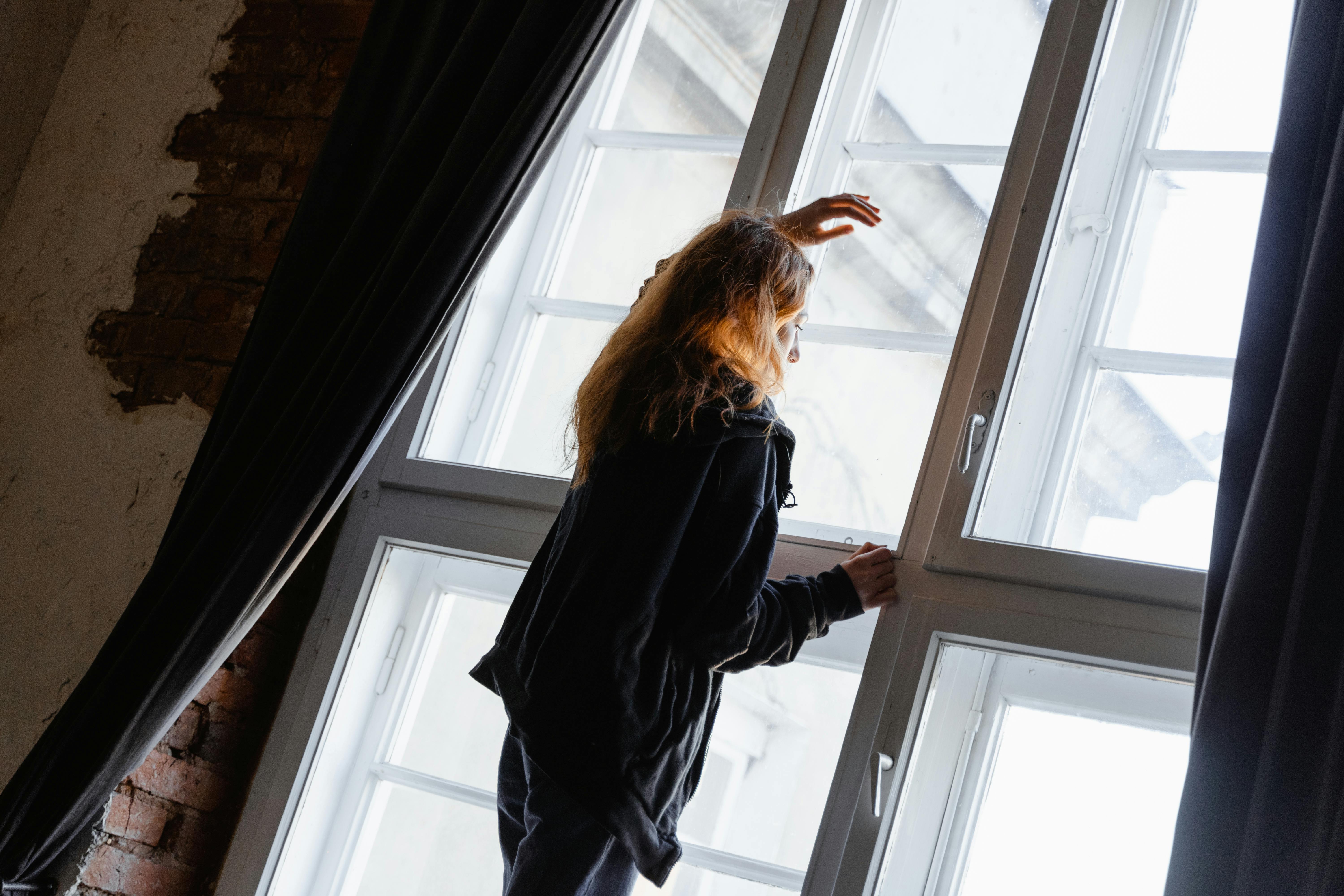 Image of woman waiting by window to go with Blog Post for tips for ADHD waiting mode and how to use the time