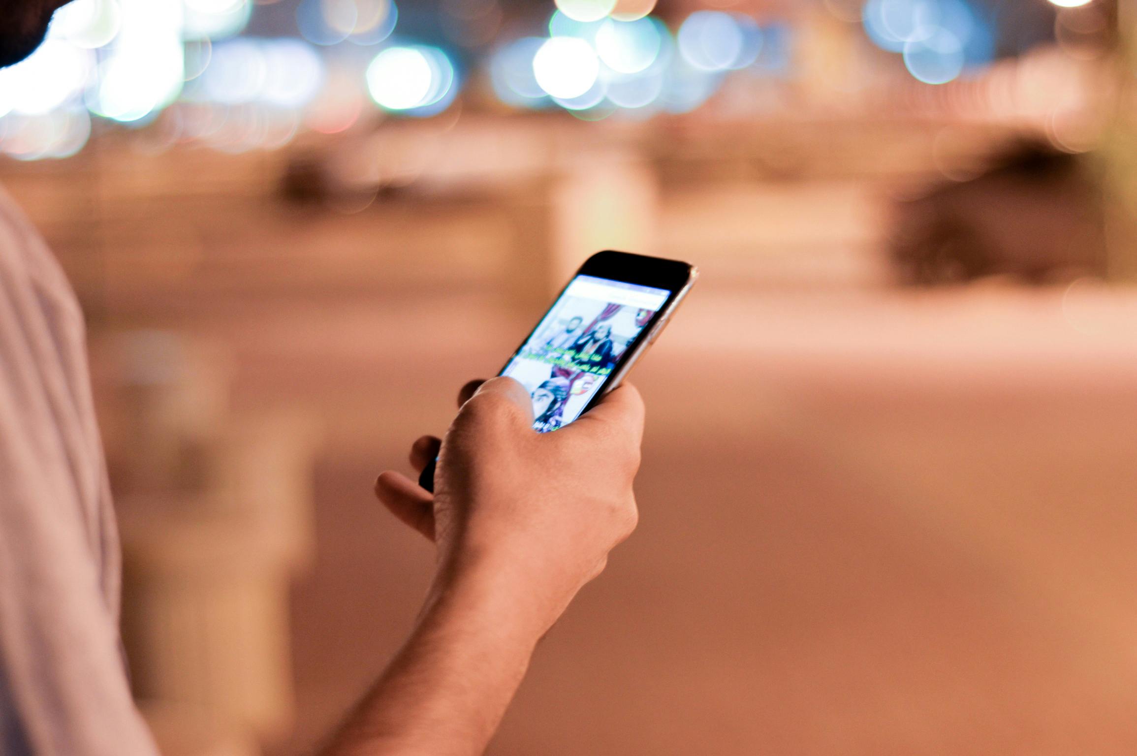 Man holding phone scrolling social media to support blog post Understanding ADHD, Autism and Aphantasia Connection