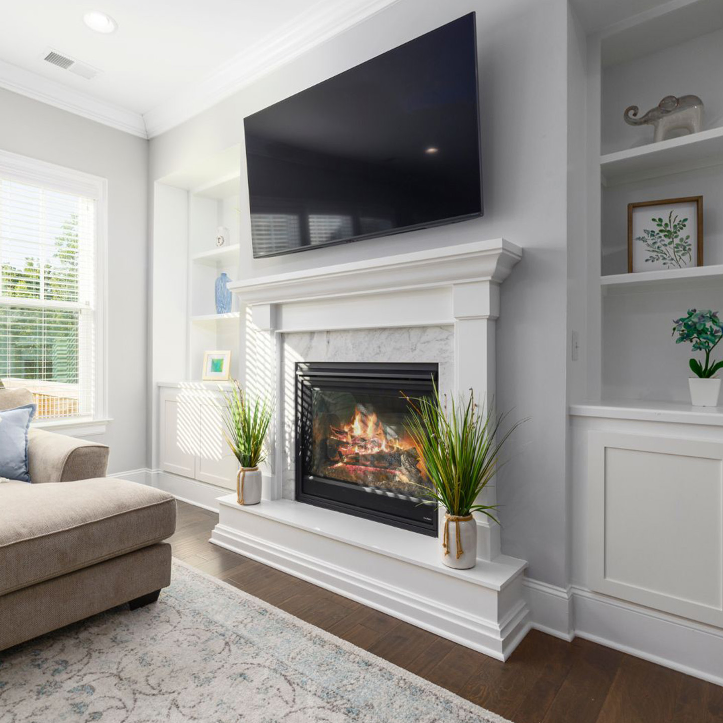 Home addition in Garland TX featuring a cozy living room with built-in shelving, fireplace, and natural lighting