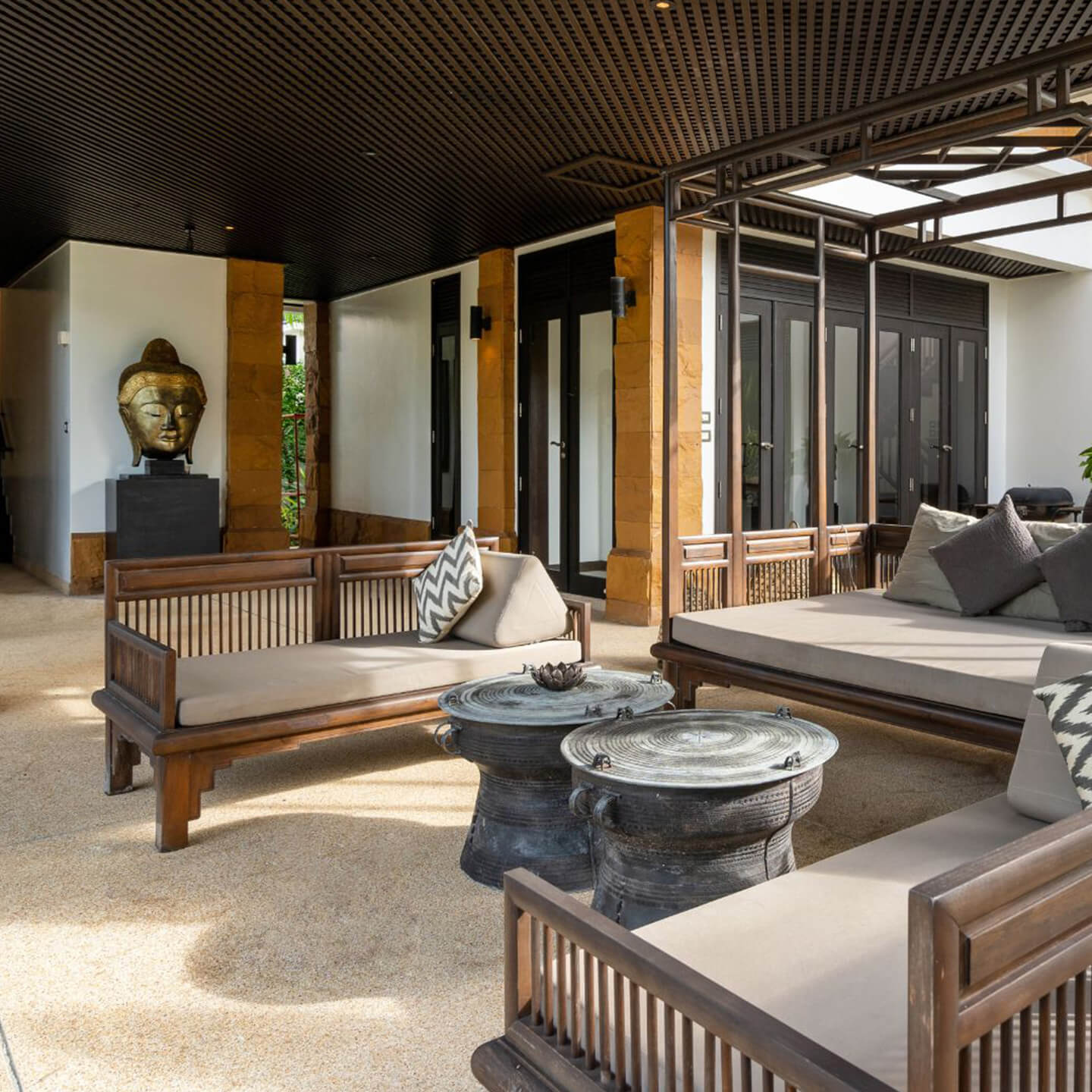 Custom pavilion in Garland TX featuring a covered outdoor lounge area with wood furniture, shaded roof structure, and modern design