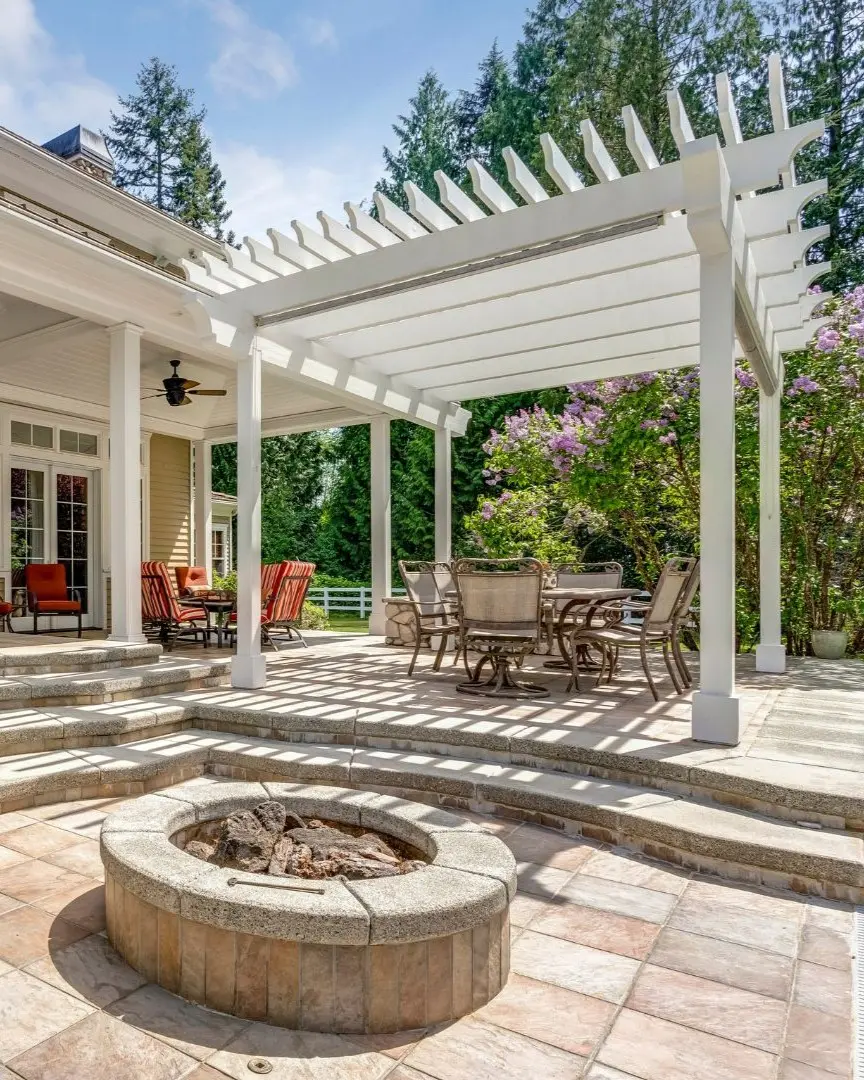 Custom pergola and patio cover in Flower Mound TX with outdoor dining area and stone fire pit