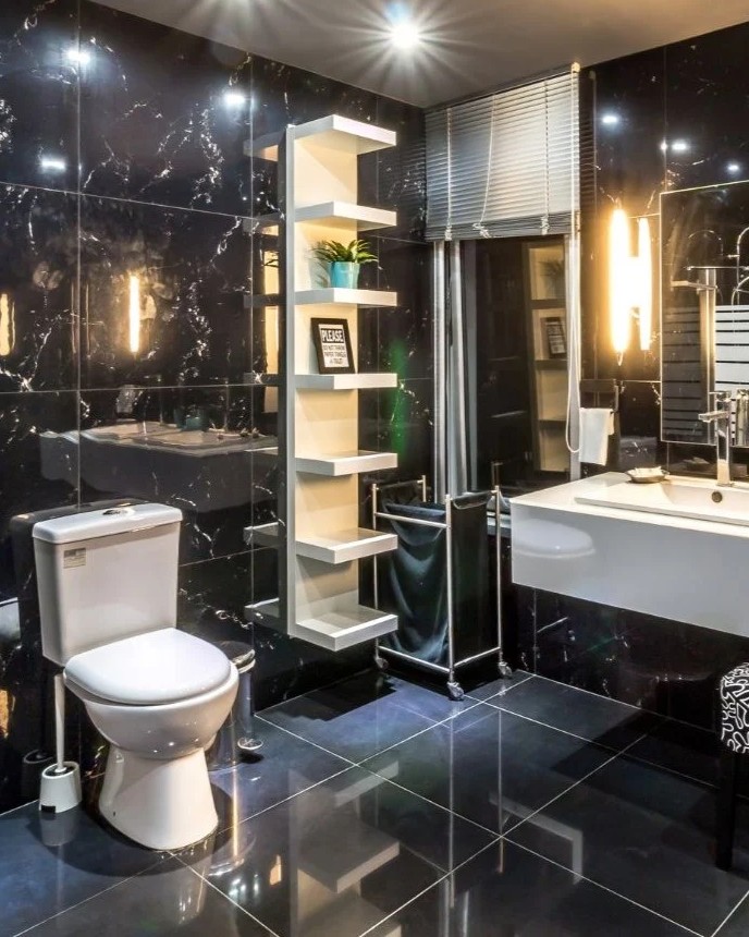 Modern bathroom renovation in Dallas, TX with black tile walls, updated fixtures, and custom shelving