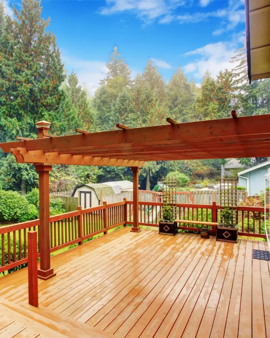 Wooden pergola and patio cover built in Dallas, TX providing shade and style for an outdoor living space