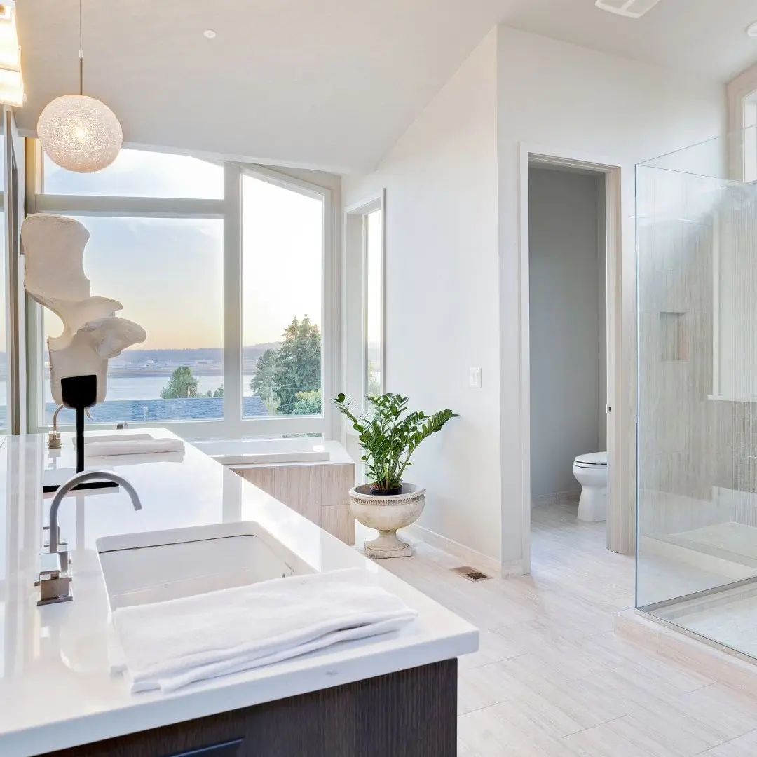 Modern bathroom remodel in Sachse TX with double sinks, large glass shower, and lake view windows.