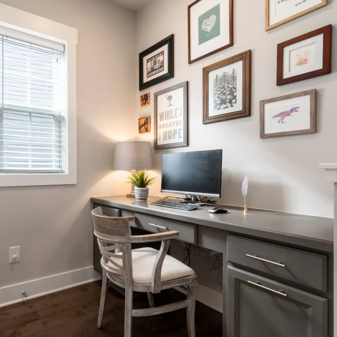Home office remodel in Sachse TX with built-in desk, wall decor, and natural lighting.