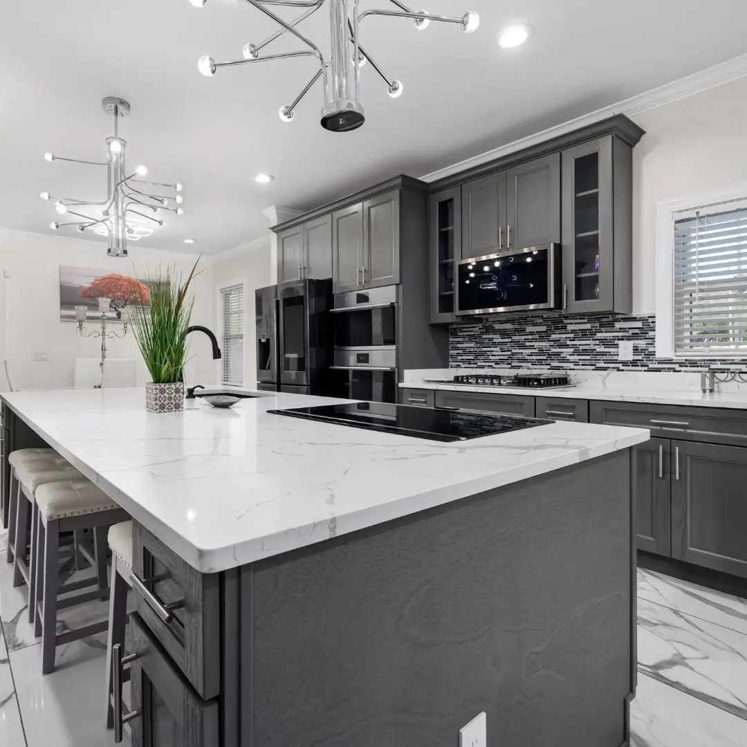 Modern kitchen remodel in Wylie, TX with gray cabinets, quartz island, tile flooring, and updated lighting