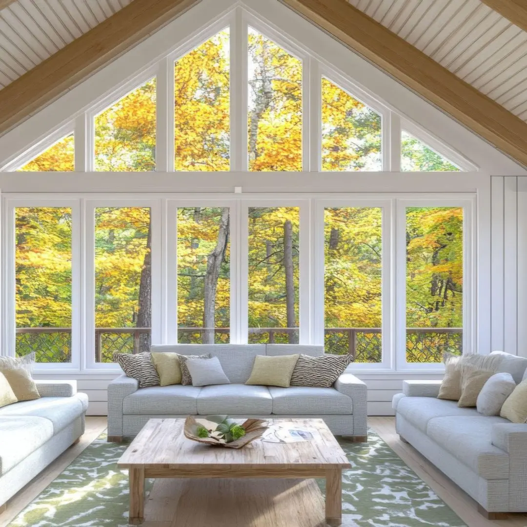 Bright living room with vaulted ceiling, exposed beams, and wall of windows in Rowlett TX home addition