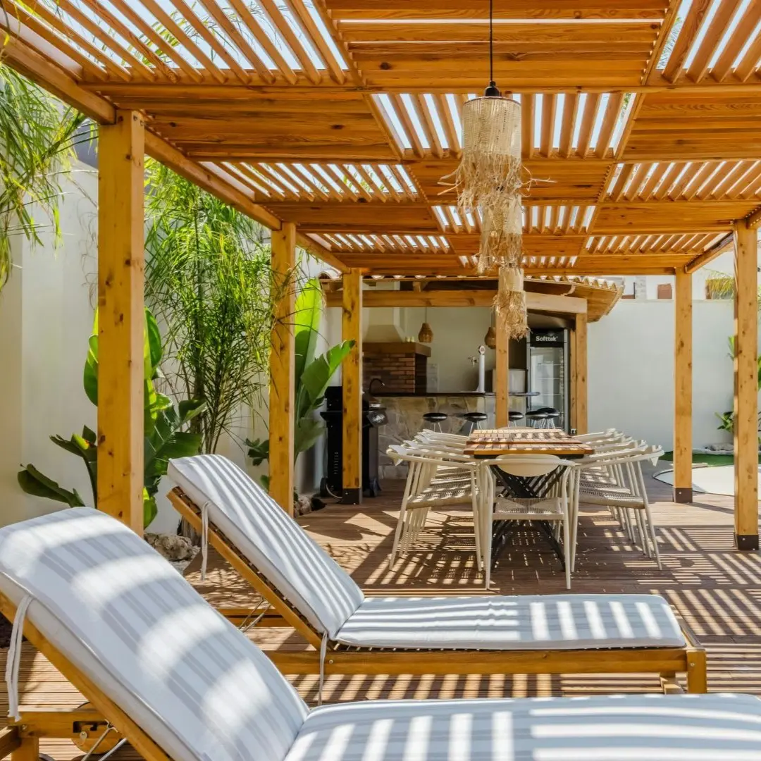Cedar pergola with outdoor dining and poolside lounge in Coppell, TX