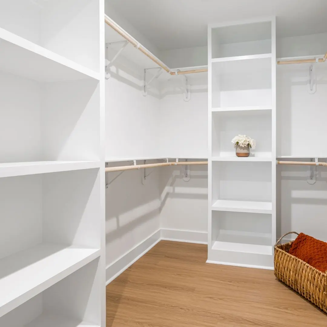 Walk-in closet with built-in shelves and hanging rods in a home addition in Farmers Branch, TX
