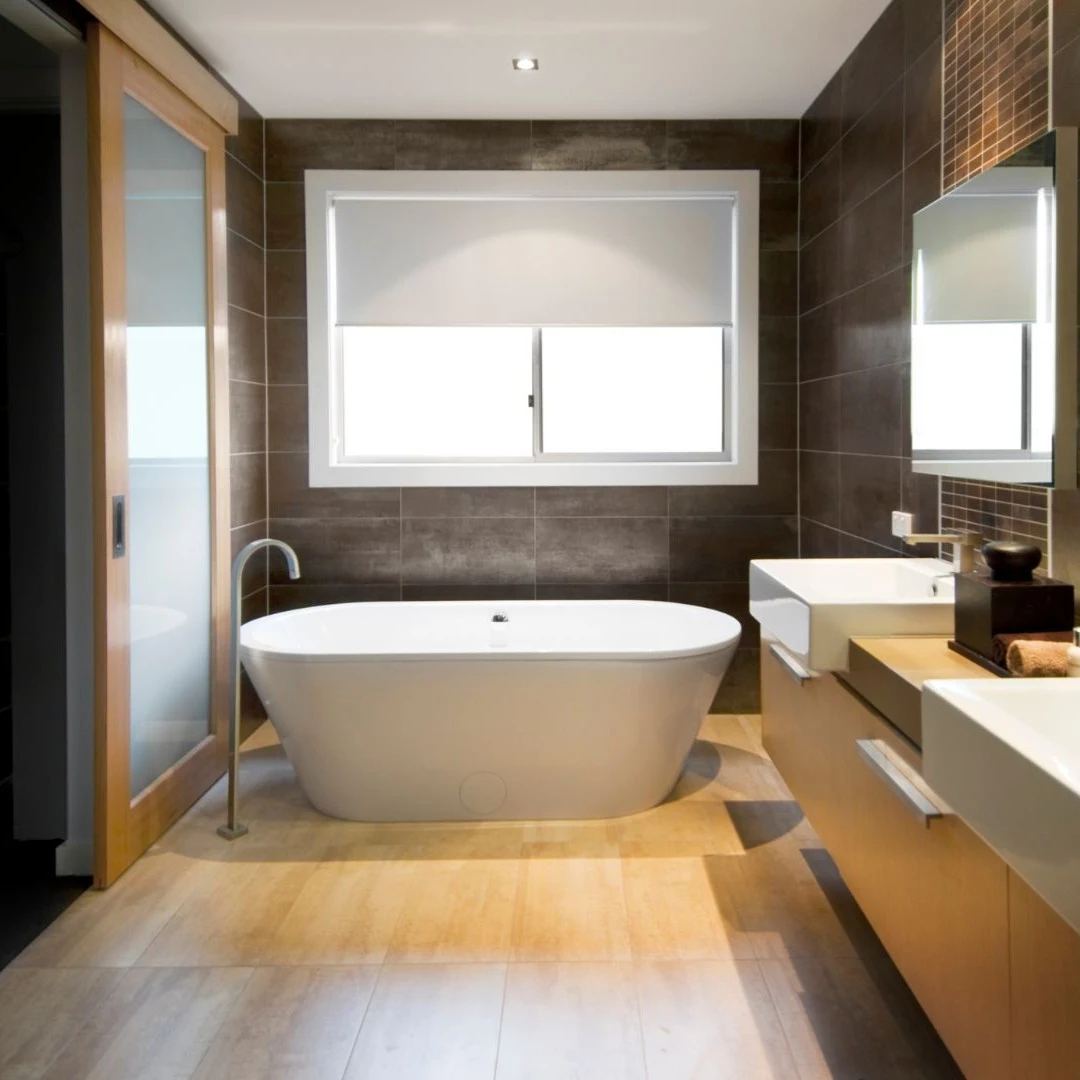 Modern bathroom remodel in Lewisville TX with freestanding tub, dual sinks, and updated tile finishes