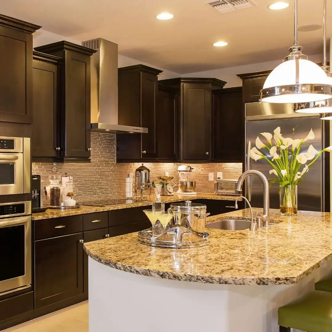 Modern kitchen remodel with dark cabinets, granite countertops, stainless appliances, and pendant lighting in Highland Village TX