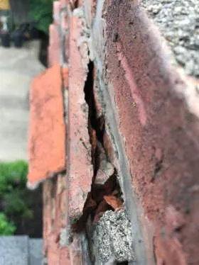 This chimney has several bricks where the face is breaking off. This is called spalling and is typically caused by water penetrating the bricks and freezing. This chimney has several bricks where the face is breaking off. This is called spalling and is typically caused by water penetrating the bricks and freezing.