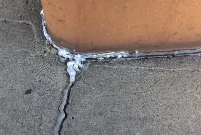 The crack in this crown is wide enough to let water enter and cause further damage. Attempts to fix with caulk are more of a band-aid than a permanent fix.