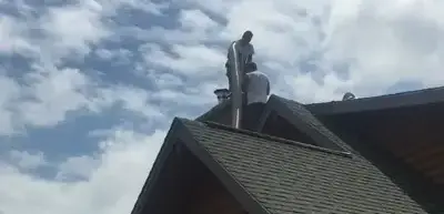 Chimney Works installers put a new stainless steel liner in an existing clay flue tile liner. Chimney Works installers put a new stainless steel liner in an existing clay flue tile liner.