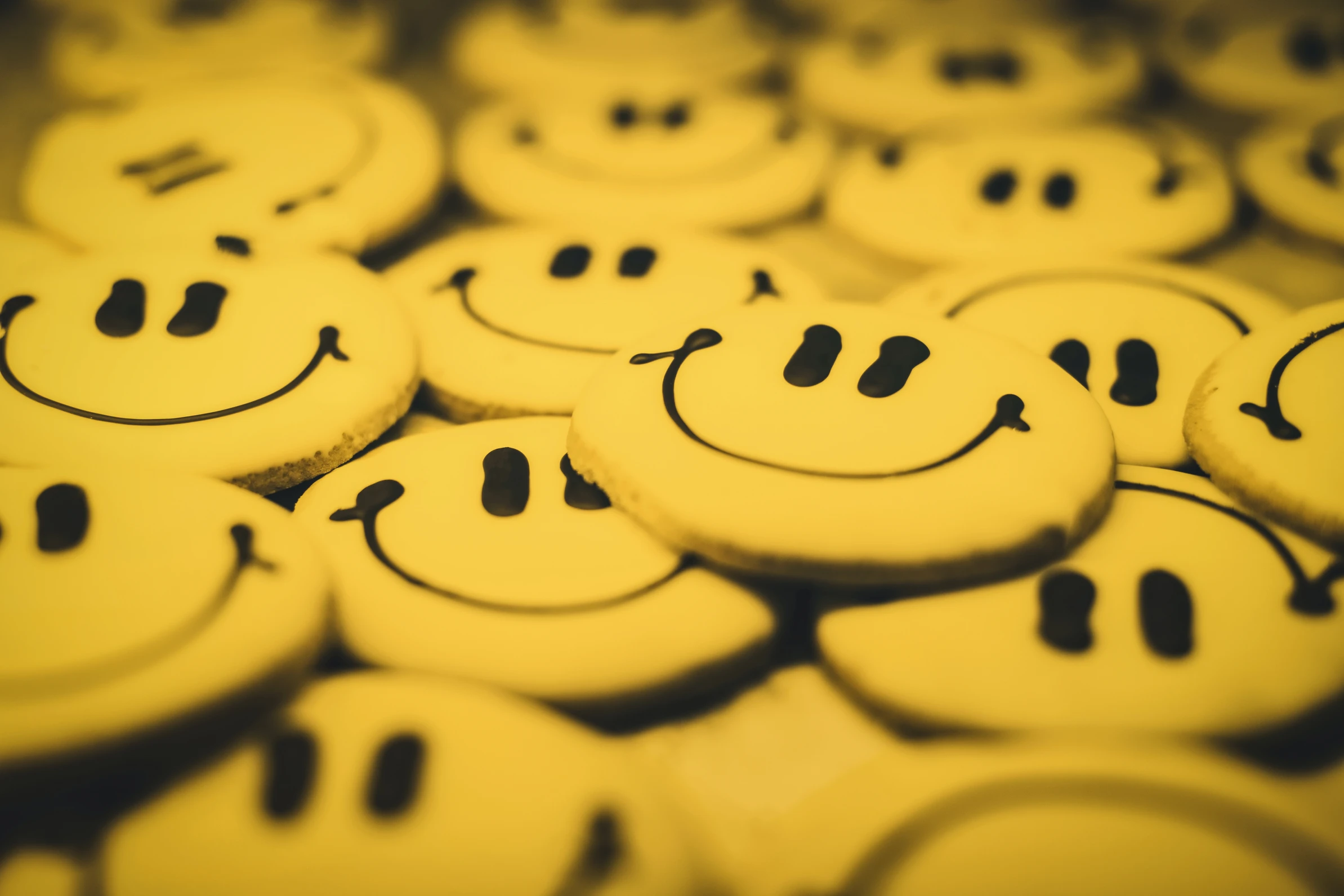 A stack of yellow smiley faces, radiating happiness and positivity.