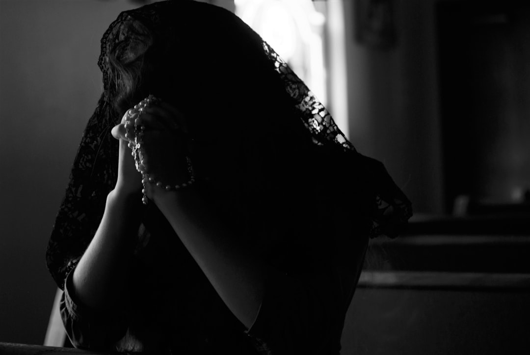An overwhelmed adult daughter sits at a table with paperwork, while a senior parent looks on—representing the emotional toll and complexity of caregiving alone. An overwhelmed adult daughter sits at a table with paperwork, while a senior parent looks on—representing the emotional toll and complexity of caregiving alone.