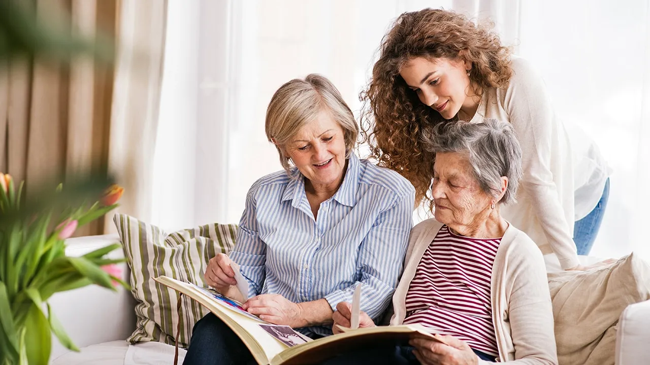 A kind caregiver chats with an elderly woman at home, representing the warmth and support of companion care services for seniors aging in place. A kind caregiver chats with an elderly woman at home, representing the warmth and support of companion care services for seniors aging in place.
