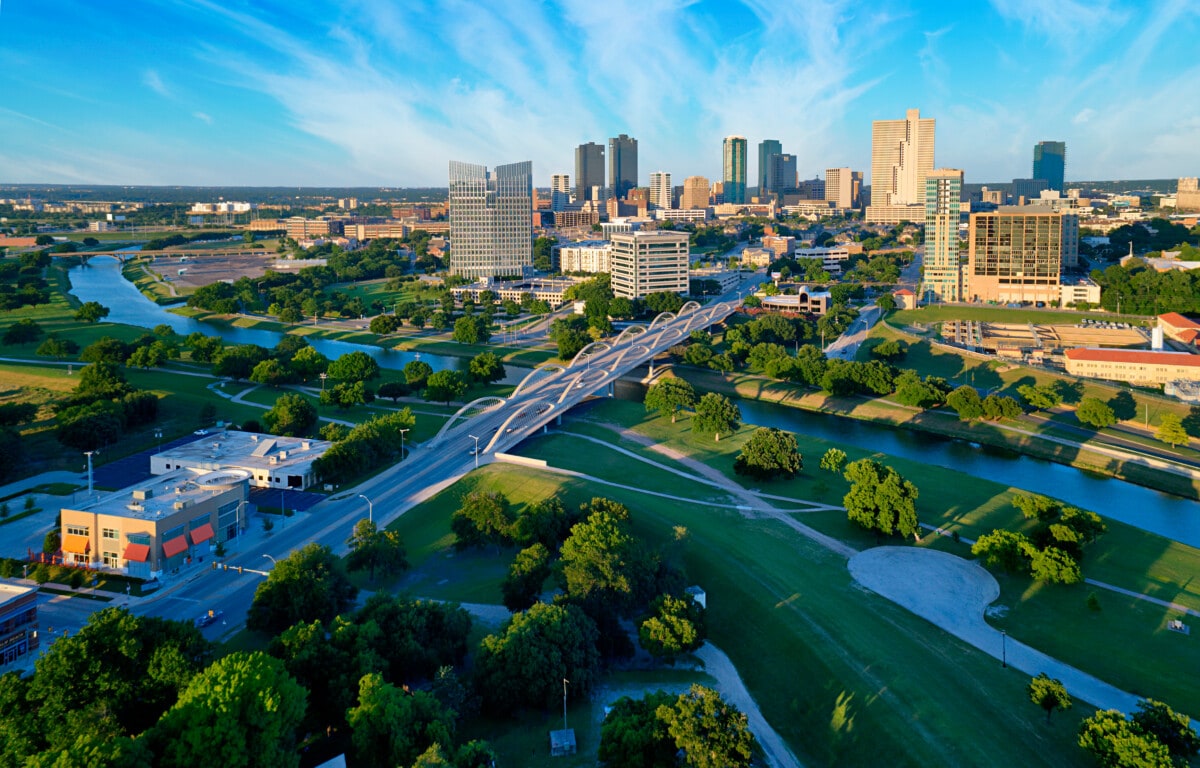 Aerial view of Fort Worth suburban neighborhood with tree-lined streets and single-family homes, highlighting local housing market trends in 2025.