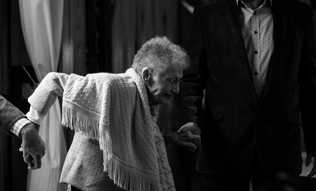 An elderly woman struggles to stand up without assistance An elderly woman struggles to stand up without assistance