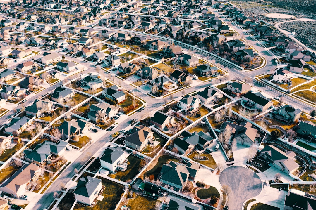 Aerial view of suburban Dallas–Fort Worth homes in summer 2025, showing mixed real estate development and mature neighborhoods