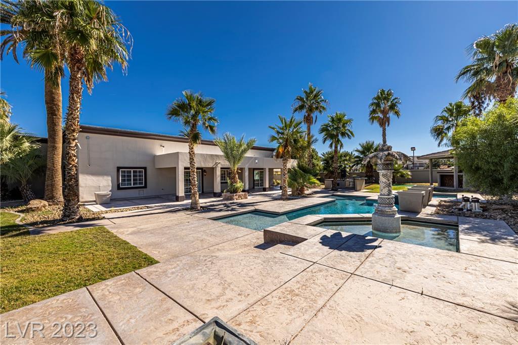 Backyard picture of the pool and gardens