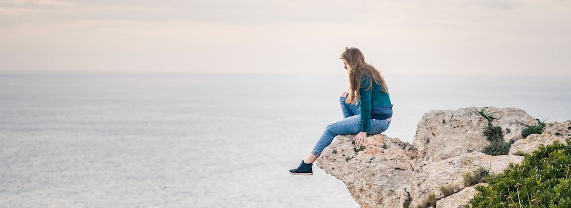 woman brave enough to break the rules - looking over waterfall 