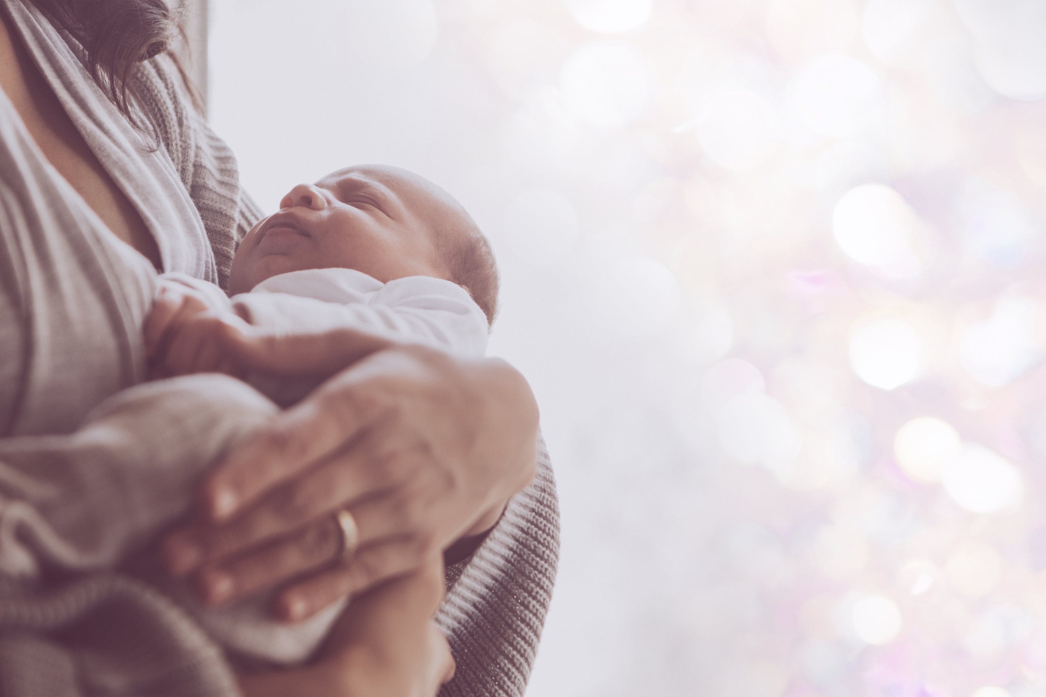 Woman holding baby - caretaker 