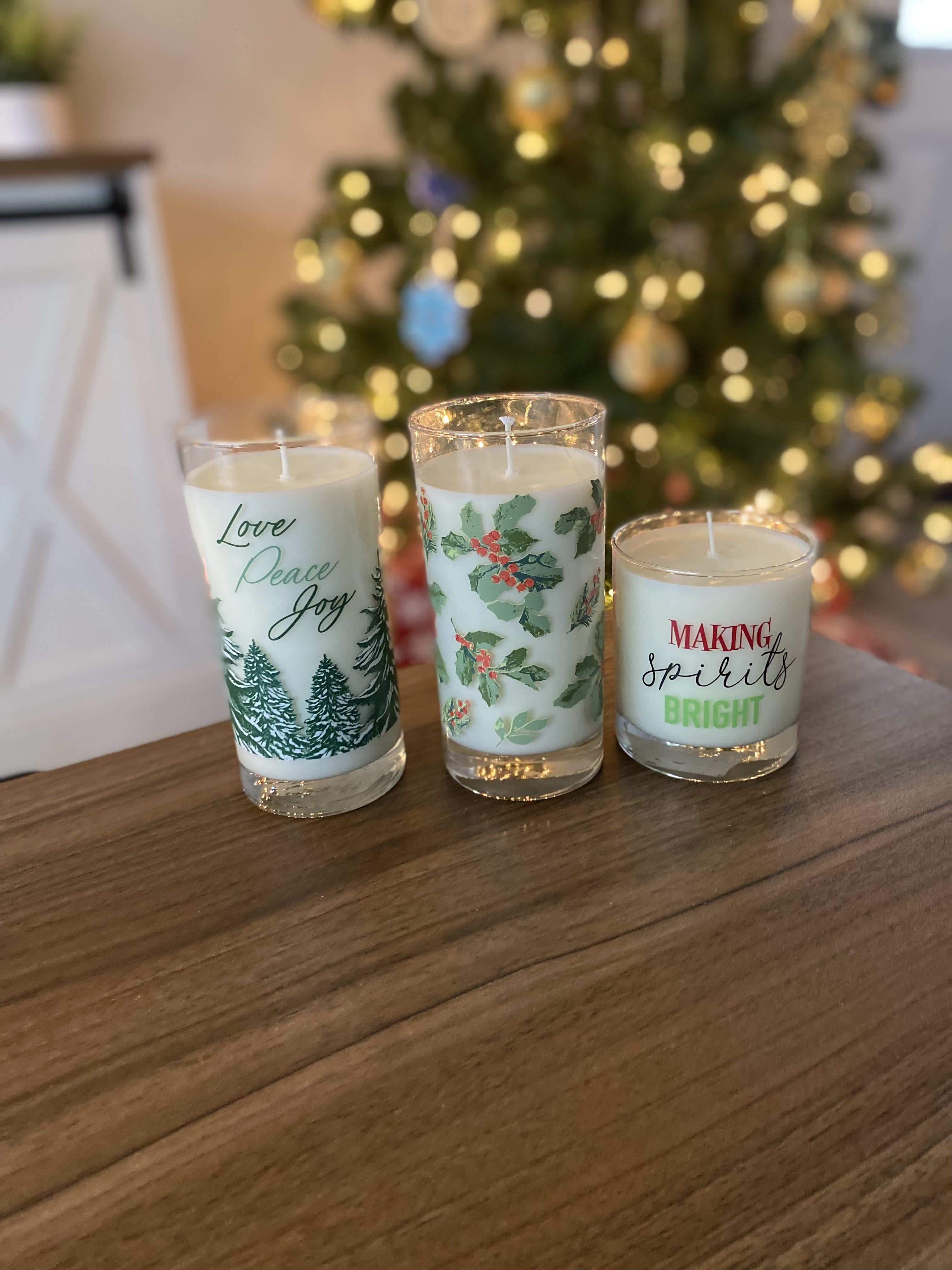 Three beautifully finished, holiday-themed candles.