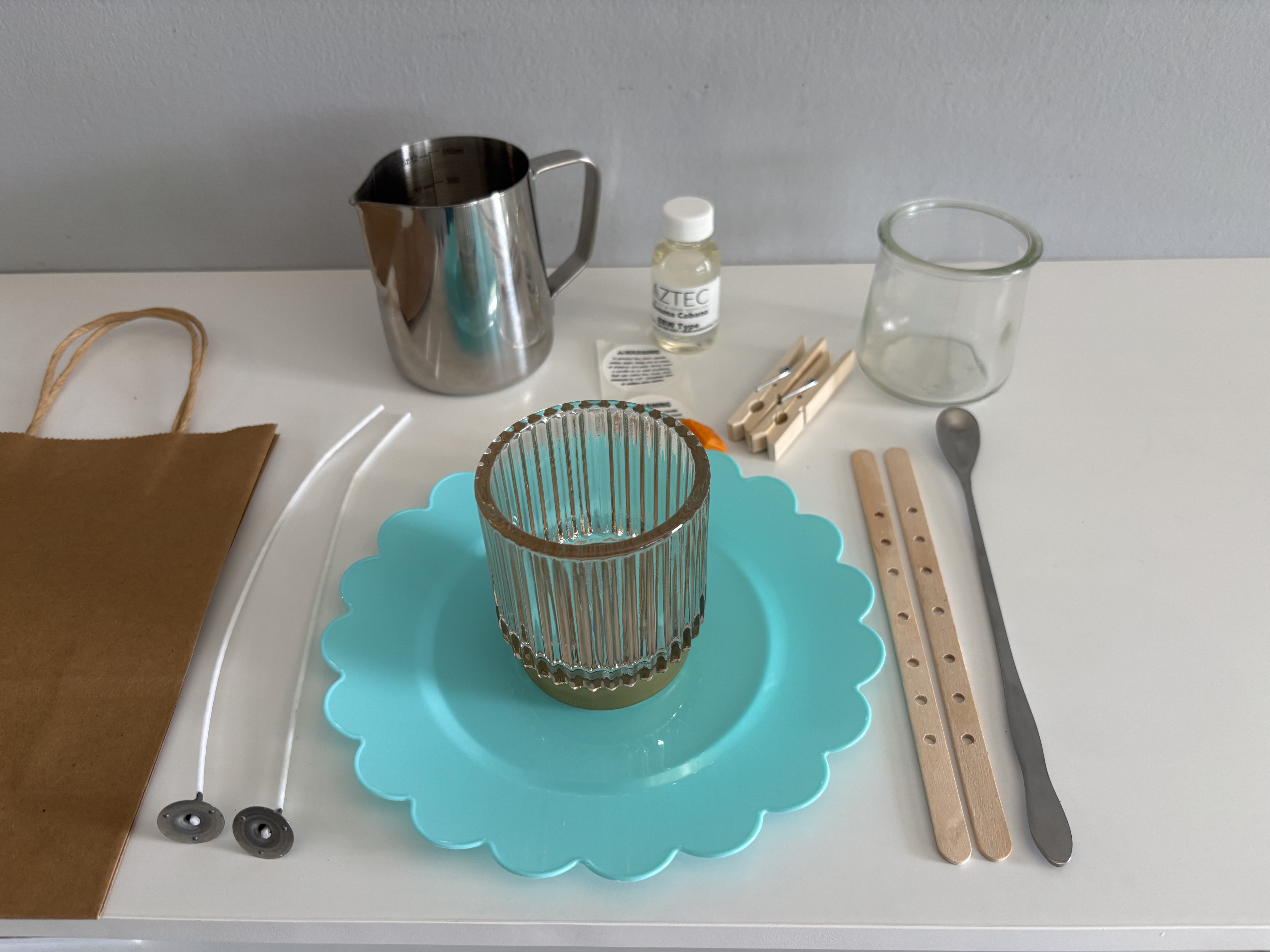 The materials for a single candle making place setting.