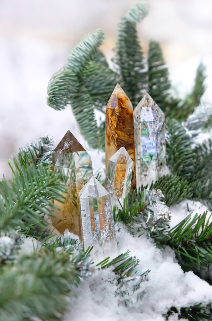 Pine branches and crystals are nestled in snow Pine branches and crystals are nestled in snow